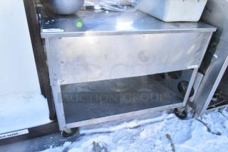 Duke 333 M Stainless Steel Counter w/ Under Shelf on Commercial Casters.