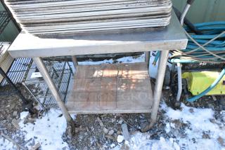 Stainless Steel Table w/ Under Shelf on Commercial Casters.