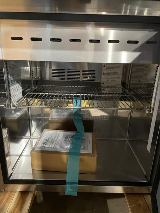 BRAND NEW! IN THE BOX! Turbo Air Super Deluxe Series Commercial Stainless Steel 1 Door Refrigerated Bain Marie Style Mega Top Sald/Sandwich Prep Table! With Chrome Plated Wire Racks! With Removable Cutting Board! With Clear Polycarbonate Food Pans! Model: TST-28SD-12-N SN: H2VTM2RI3003! 115V 1 Phase! With Casters! - Image 9 of 14