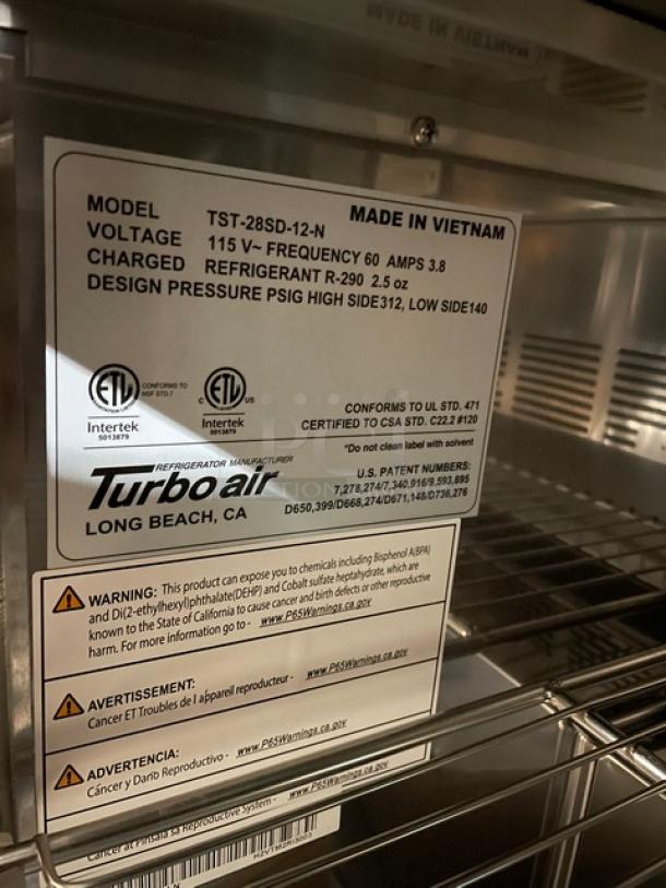 BRAND NEW! IN THE BOX! Turbo Air Super Deluxe Series Commercial Stainless Steel 1 Door Refrigerated Bain Marie Style Mega Top Sald/Sandwich Prep Table! With Chrome Plated Wire Racks! With Removable Cutting Board! With Clear Polycarbonate Food Pans! Model: TST-28SD-12-N SN: H2VTM2RI3003! 115V 1 Phase! With Casters! - Image 11 of 14