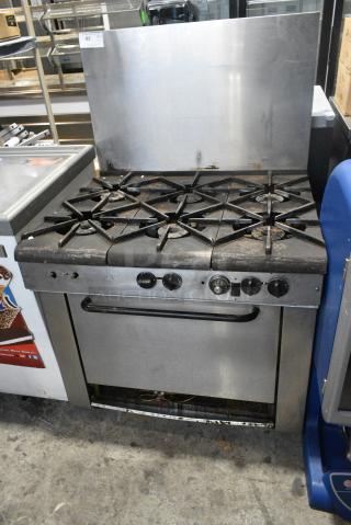 Stainless Steel Commercial Natural Gas Powered 6 Burner Range w/ Oven and Back Splash.