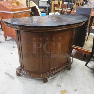 One Circular Wooden Wine Bar With A Black Granite Top, 2 Doors, 2 Drawers, Footrest, 3 Wine Bottle Shelves, And 4 Wine Glass Racks. 59X24X42