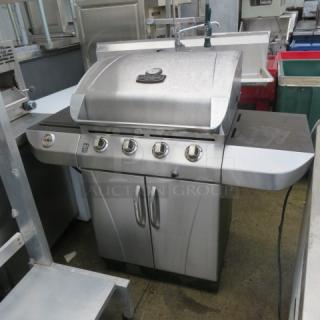 One Commercial Series Char Broil Gas Grill With 2 Side Tables, And 2 Doors On Casters.
