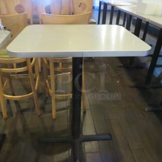 One Laminate Table Top On A Bar Height Pedestal Bases. 24X30X42