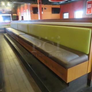 One 27 Foot,  3 Section Single Sided Waiting Bench With Green Cushioned Back And A Brown Cushioned Bottom. 324X27X41