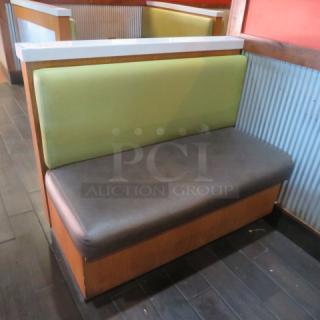 One Single Sided Wooden Booth With A Green Cushioned Back And Brown Cushioned Bottom, Finished Back, And A Marble Top. 48.5X27X41