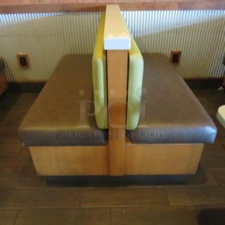 One Double Sided  Wooden Booth With A Green Cushioned Back And  A Brown Cushioned Seat And Marble Top. 60.5X48X41