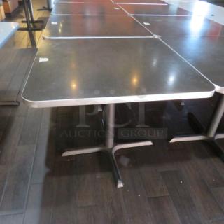 One Brown Laminate Table Top On A Pedestal Base. 36X36X30