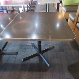 One Brown Laminate Table Top On A Pedestal Base. 36X40X30