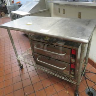 One Stainless Steel Table With A Metro Under Shelf On Casters. 48.5X24X39