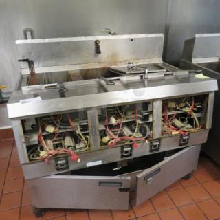One Henny Penny  Natural Gas 3 Vat Open Fryer On Casters With 5 Baskets. Model# OFG-323.  120 Volt. Missing Front Panels. 49.5X33.5X44. $25,367.00