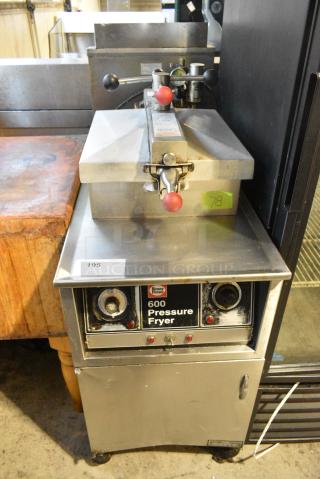 Henny Penny 600 Stainless Steel Commercial Floor Style Natural Gas Powered Pressure Fryer on Commercial Casters. 80,000 BTU.