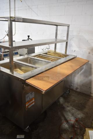 BRAND NEW SCRATCH AND DENT! 2022 Delfield SH-4 Stainless Steel Commercial Floor Style 4 Bay Steam Table on Commercial Casters. 120/208 Volts, 1 Phase.
