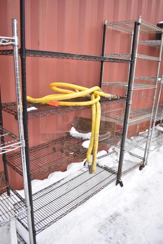 Black Finish 4 Tier Wire Shelving Unit w/ Contents Including Gas Hoses. BUYER MUST DISMANTLE. PCI CANNOT DISMANTLE FOR SHIPPING. PLEASE CONSIDER FREIGHT CHARGES.