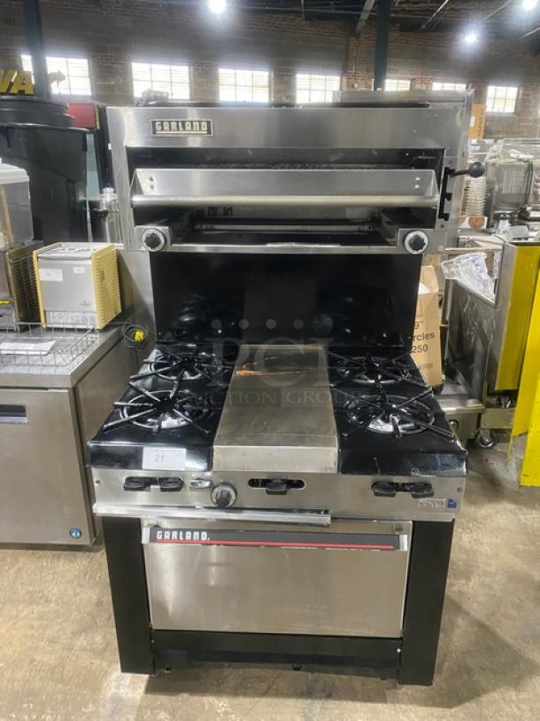 Garland Commercial Stainless Steel Natural Gas Powered 4 Burner Range/Center Flat Griddle & Oven Combo! With Back Splash & Garland Natural Gas Powered Overhead Salamander Broiler/Cheese Melter! On Legs! - Image 1 of 10