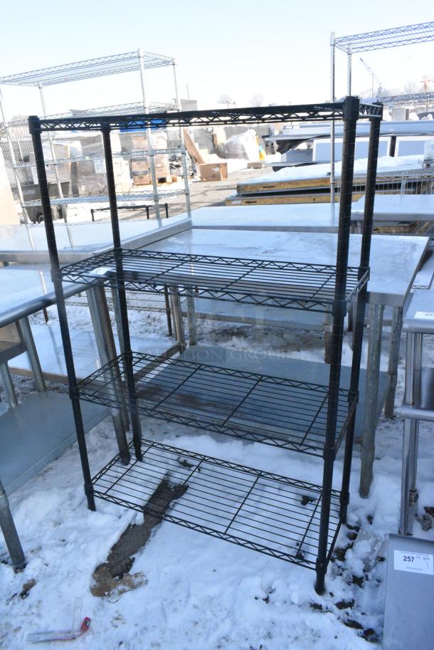 Black Finish 4 Tier Wire Shelving Unit. BUYER MUST DISMANTLE. PCI CANNOT DISMANTLE FOR SHIPPING. PLEASE CONSIDER FREIGHT CHARGES. - Image 1 of 3