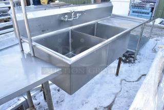 Stainless Steel 2 Bay Sink w/ Right Side Drain Board, Faucet and Handles. 1 Leg Needs To Be Reattached.