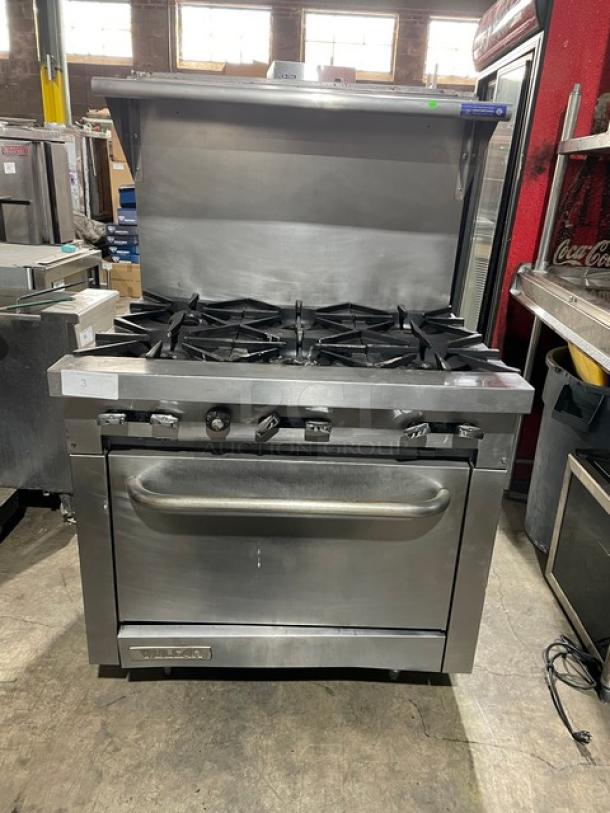 Vulcan Commercial Stainless Steel Natural Gas Powered 6 Burner Range/Oven Combo! With Back Splash & Overhead Salamander Shelf! With Wired Oven Rack! On Legs! - Image 1 of 11