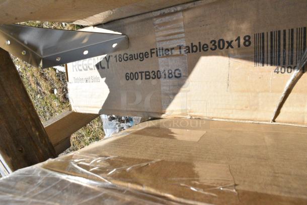 BRAND NEW SCRATCH AND DENT! Reegency 600TB3018G 30" x 18" 18-Gauge 304 Stainless Steel Equipment Filler Table with Backsplash and Galvanized Undershelf. May Be Missing Pieces. Stock Picture Used as Gallery - Image 3 of 3