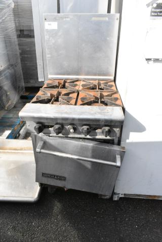 American Range Stainless Steel Commercial Gas Powered 4 Burner Range w/ Oven and Back Splash on Commercial Casters.