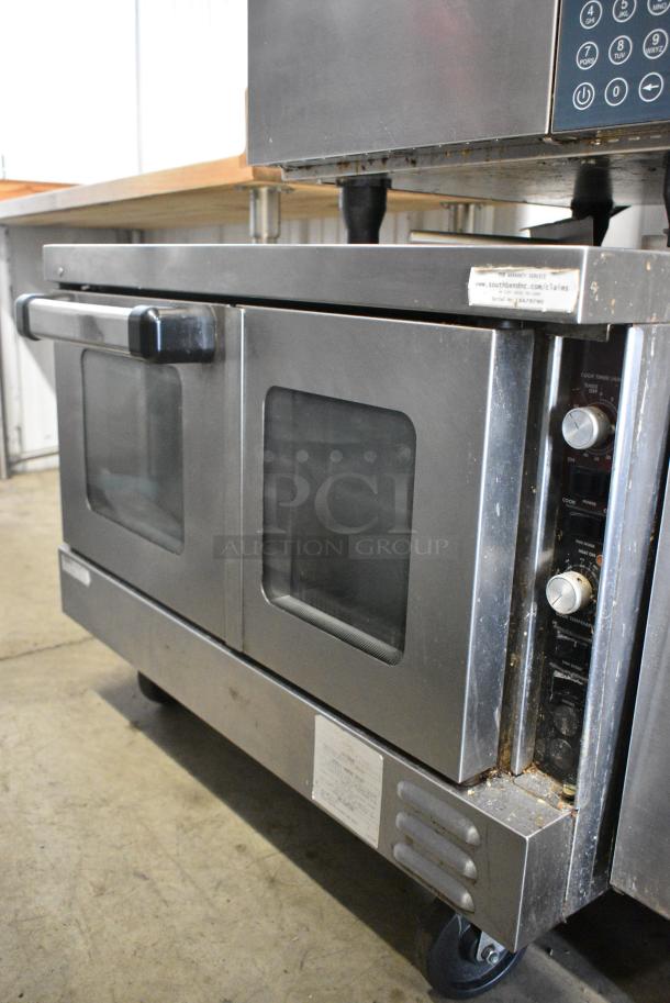 Southbend TVGS/12SC Stainless Steel Commercial Natural Gas Powered Convection Oven w/ View Through Doors, Metal Oven Racks and Thermostatic Controls on Commercial Casters. - Image 1 of 8