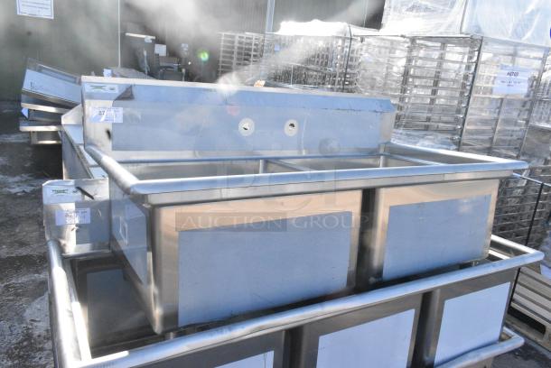 BRAND NEW SCRATCH AND DENT! Regency 600S22323 96" 16-Gauge Stainless Steel Two Compartment Commercial Sink with Stainless Steel Legs, Cross Bracing, and 2 Drainboards - 23" x 23" x 12" Bowls. No Legs. - Image 1 of 5
