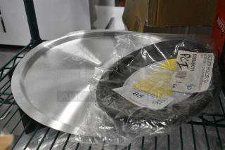 2 BRAND NEW SCRATCH AND DENT! Items Including 471SPC60 Choice 16 15/16" Aluminum Pot / Pan Cover and Lodge US011 Black 8 3/4" x 13" Oval Heat-Resistant Black Silicone Underliner. 2 Times Your Bid!