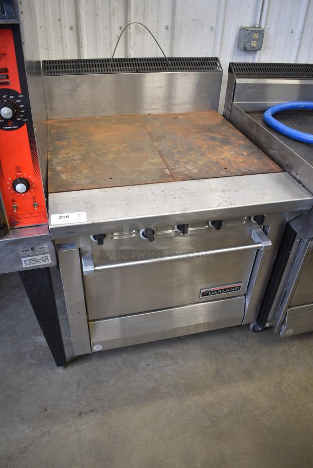 Garland M46R Stainless Steel Commercial Natural Gas Powered Flat Top Griddle w/ Oven and Back Splash. - Image 1 of 6