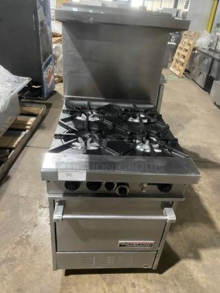 Garland Commercial Stainless Steel Natural Gas Powered 4 Burner Range/Oven Combo! With Back Splash & Overhead Salamander Shelf! With Wire Oven Rack! Model: H28 SN: 0701100159611! On Legs!