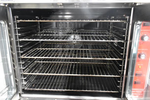 BRAND NEW SCRATCH AND DENT! Migali C-C01-SD-NG Stainless Steel Commercial Natural Gas Powered Full Size Convection Oven w/ View Through Doors, Metal Oven Racks, Thermostatic Controls and Metal Legs on Commercial Casters. - Image 6 of 8