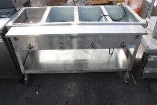 4 Well Electric Steam Table With Undershelf & 8" Deep Cutting Board, On Commercial Casters In working Order.