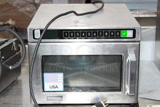 BRAND NEW SCRATCH & DENT! Amana HDC1815 Heavy-Duty Stainless Steel Commercial Microwave with Push Button Controls - 208/240V, 1800W, 14.4 Amps, 1 Phase, 60 Hz. S/N: 2410110964. Unit is dented on the sides.