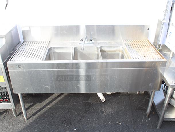 DEAL!! Glastender TSB-60-S Underbar Three Compartment Sink Unit With Drainboards, 60"x24". Sink Compartment Dimensions: 11" W X 14" Front-To-Back X 10-1/4" Deep, 12" Drainboards On Left & Right With Removable  Perforated Inserts & Deck Mount Faucet. STAINLESS STEEL CONSTRUCTION & STAINLESS STEEL LEGS!! S/N: 262843 - Image 1 of 7