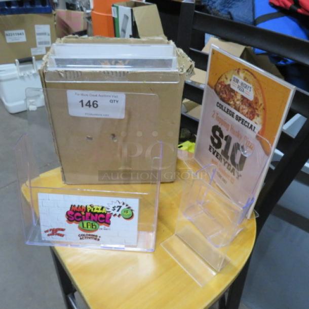 One Lot Of Assorted Poly Table Tents And Holders. - Image 1 of 1
