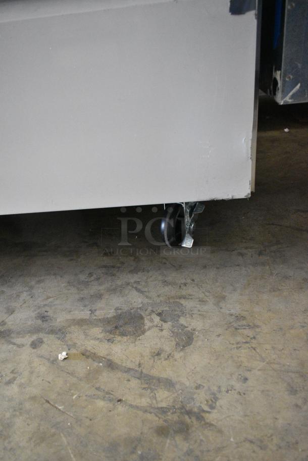BRAND NEW SCRATCH AND DENT! 2024 Avantco 178SSPPT3 Stainless Steel Commercial 94" 3 Door Refrigerated Pizza Prep Table w/ 4 Drawers and 1 Door on Commercial Casters. 115 Volts, 1 Phase. Tested and Working! - Image 12 of 14