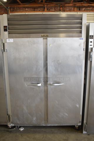 Traulsen G22010 Stainless Steel Commercial 2 Door Reach In Freezer w/ Poly Coated Racks on Commercial Casters. 115 Volts, 1 Phase. Tested and Working!
