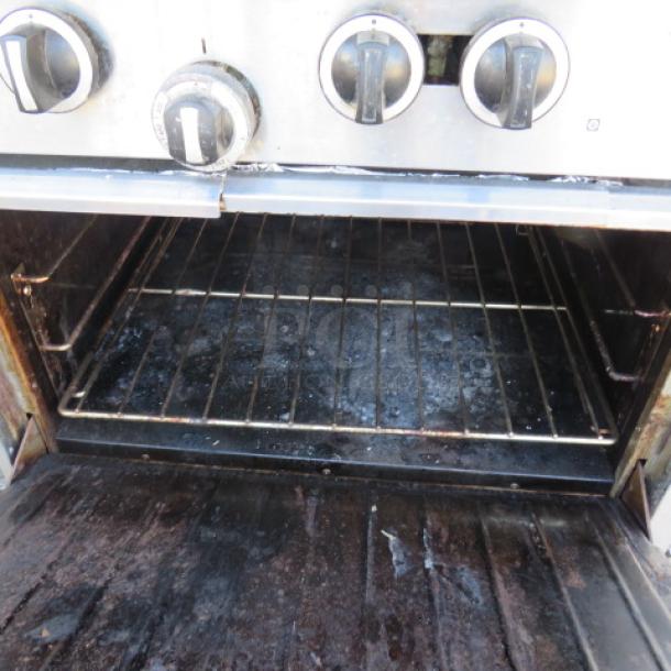 One Garland 10 Burner Natural Gas Range With Stainless Steel Over Shelf, And 2 Racks On Casters. Model# G60-10CC. 60X39X57.   $13,567.00 - Image 2 of 3