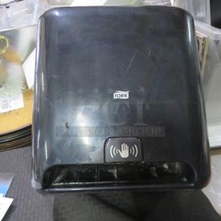 One Tork Wall Mount Hands Free Automatic Paper Towel Dispenser.