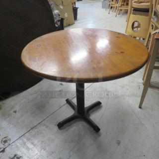 One Wooden Round Table On A Pedestal Base. 36X36X29