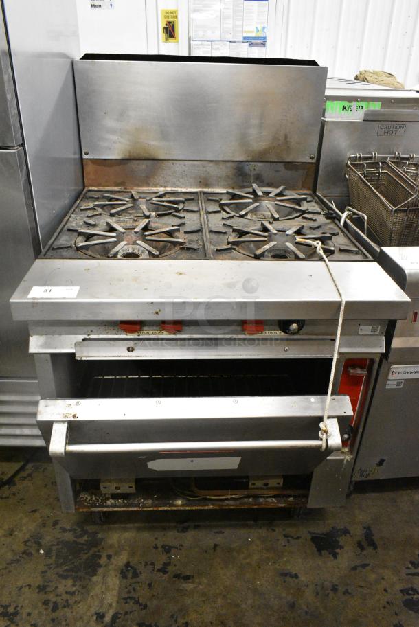 Vulcan Stainless Steel Commercial Natural Gas Powered 4 Burner Range w/ Oven and Back Splash on Commercial Casters. - Image 1 of 10