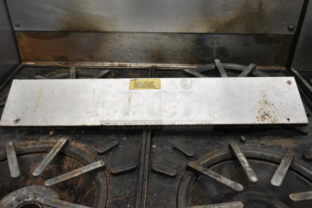 Vulcan Stainless Steel Commercial Natural Gas Powered 4 Burner Range w/ Oven and Back Splash on Commercial Casters. - Image 6 of 10