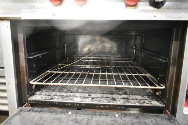 Vulcan Stainless Steel Commercial Natural Gas Powered 4 Burner Range w/ Oven and Back Splash on Commercial Casters. - Image 8 of 10