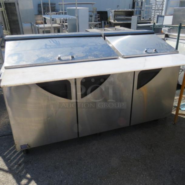 One Turbo Air 3 Door Refrigerated Prep Table With Cutting Board ANd 3 Racks, On Casters. Model# TST-72SD-30-N. 115 Volt. 73X34X45 - Image 1 of 2