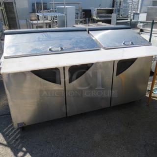 One Turbo Air 3 Door Refrigerated Prep Table With Cutting Board ANd 3 Racks, On Casters. Model# TST-72SD-30-N. 115 Volt. 73X34X45