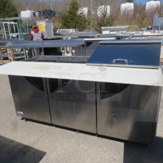 One Turbo Air 3 Door Refrigerated Prep Table With Cutting Board And 3 Racks, On Casters. Missing 1 Lid. Model# TST-72SD-30-N. 115 Volt. 73X34X45
