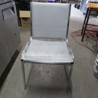 Chrome Stack Chair With Gray Cushioned Seat And Back. 2XBID