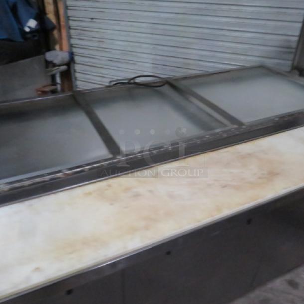 One WORKING True 3 Door Refrigerated Prep Table With 3 Racks, Cutting Board, And SS Over Shelf With A Lift Top, On Casters. Model# TSSU-72-30M-B-ST. 115 Volt. 72X35X60.5. $5764.77. - Image 2 of 3