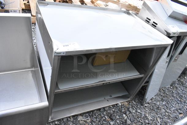 BRAND NEW SCRATCH AND DENT! Regency 600CT3S2133E 21" x 33" Three Shelf 18-Gauge 304 Stainless Steel Utility Cart with Enclosed Base and Open Front - Image 1 of 7