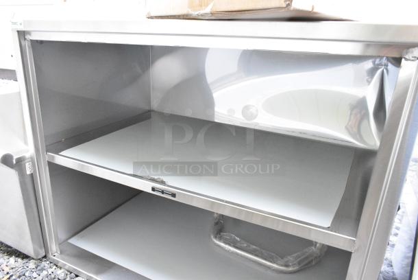BRAND NEW SCRATCH AND DENT! Regency 600CT3S2133E 21" x 33" Three Shelf 18-Gauge 304 Stainless Steel Utility Cart with Enclosed Base and Open Front - Image 5 of 7
