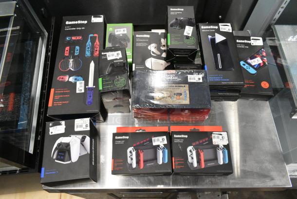 ALL ONE MONEY! Lot of IN ORIGINAL BOX! Items Including Nintendo Switch Charger / Game Docks, Nintendo Switch Controller Grip Kit, VP Protection Kit, PlayStation 5 Disc Edition Console Silicone Cover - Image 1 of 5